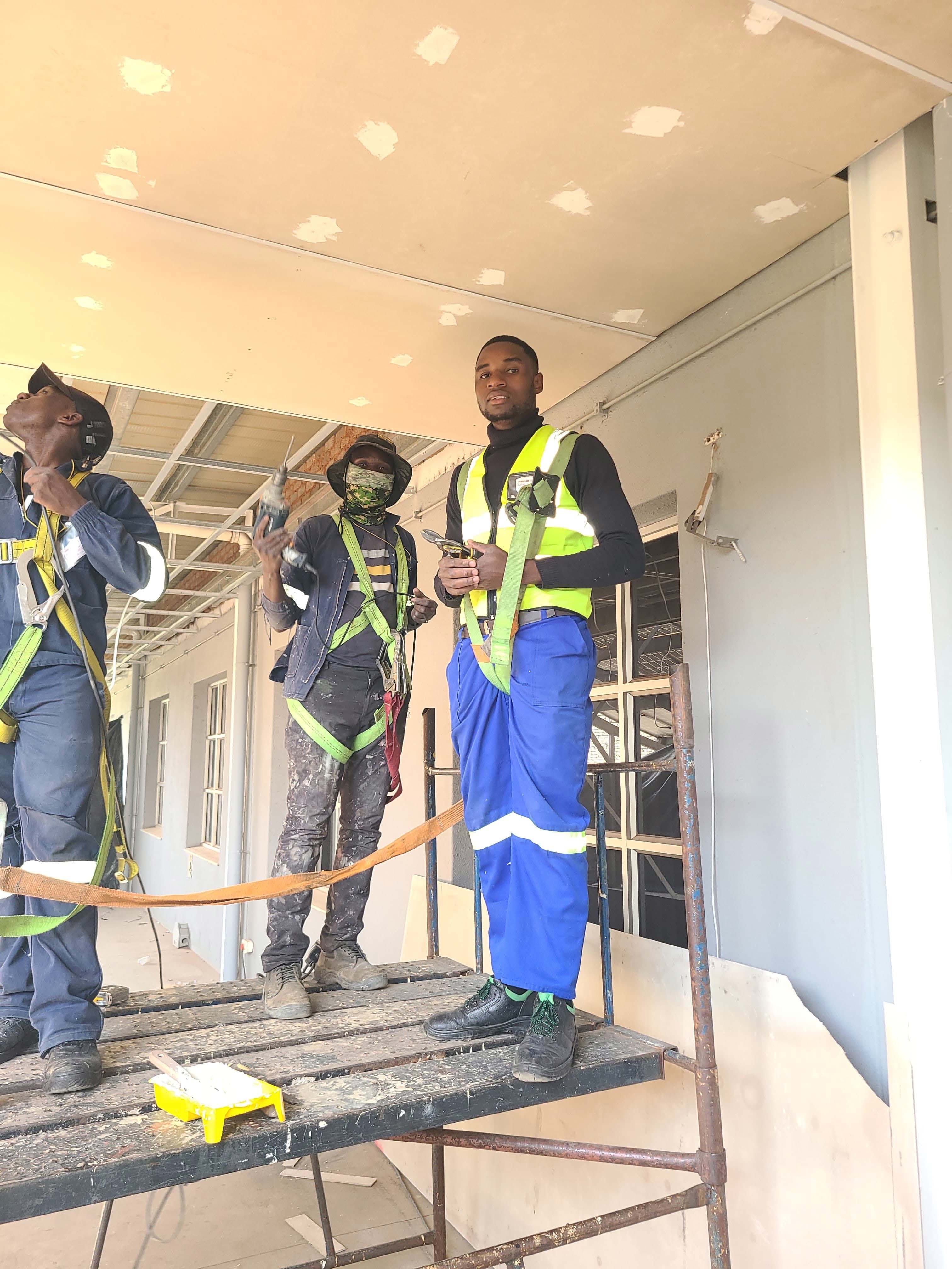 Maintenance team working on ceiling repairs at a commercial building