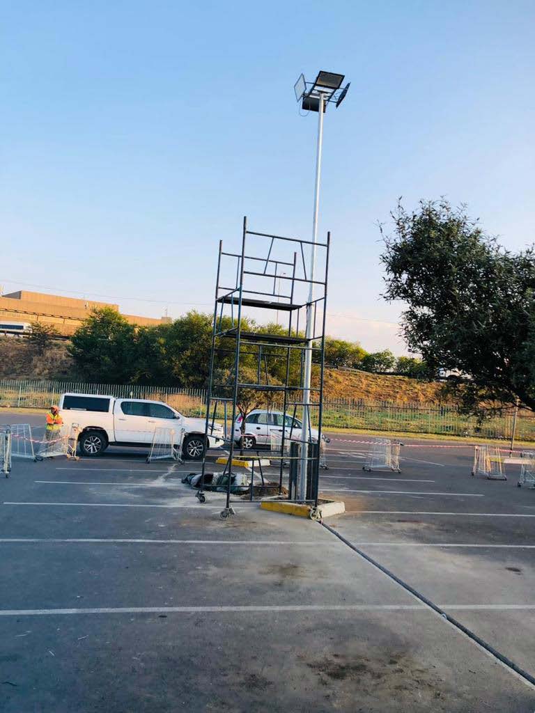 Scaffold tower set up for parking area light maintenance