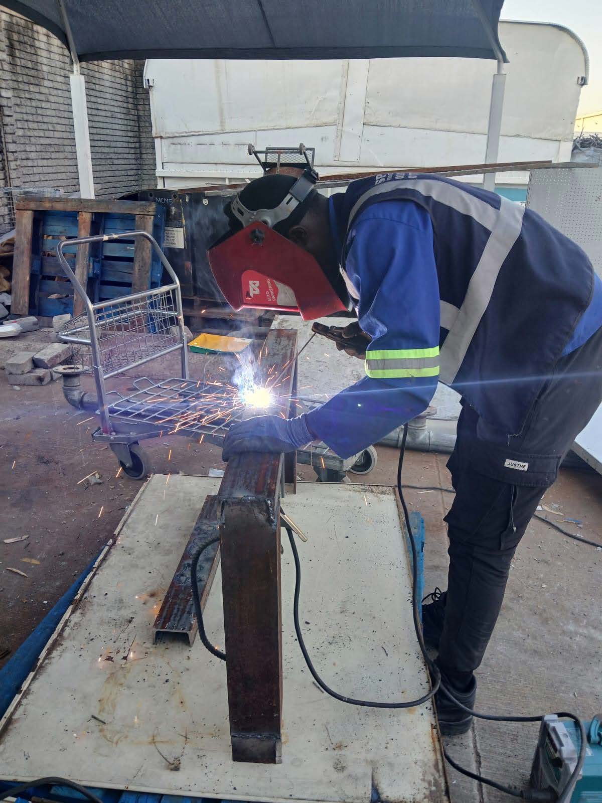Sparks team member welding steel for maintenance fabrication
